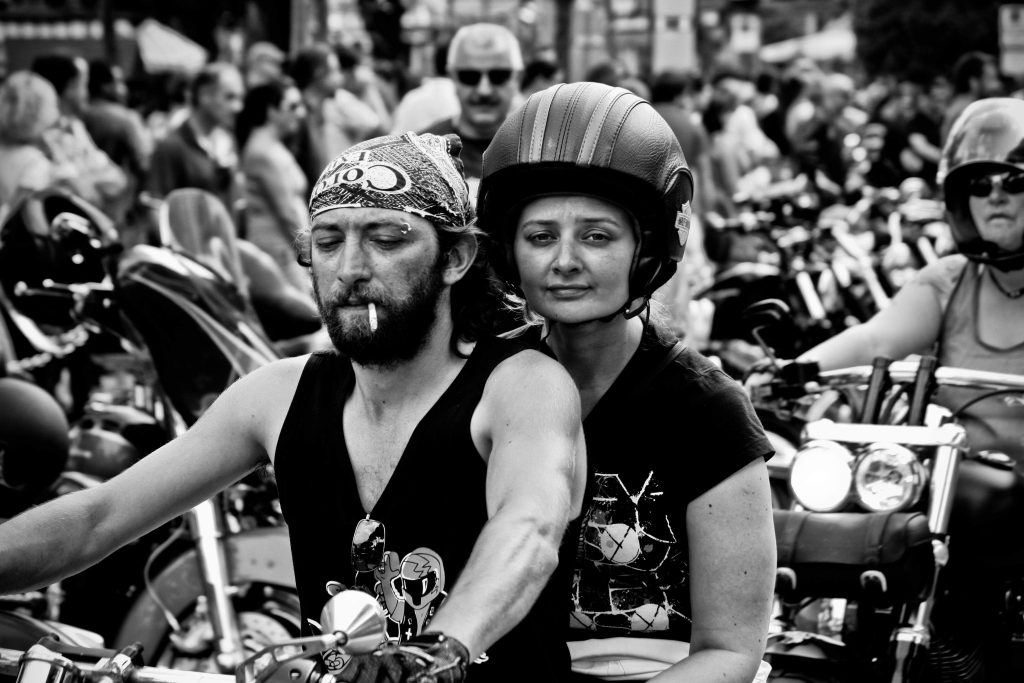 The Home of The Global Association of One Percenters 1 couple on a bike during a festival, black and white for the Global Association of One Percenters and global club membership